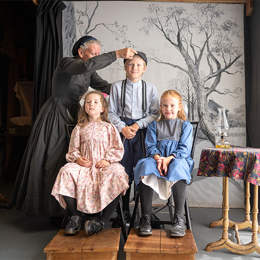 Family setting up for an ambrotype photo