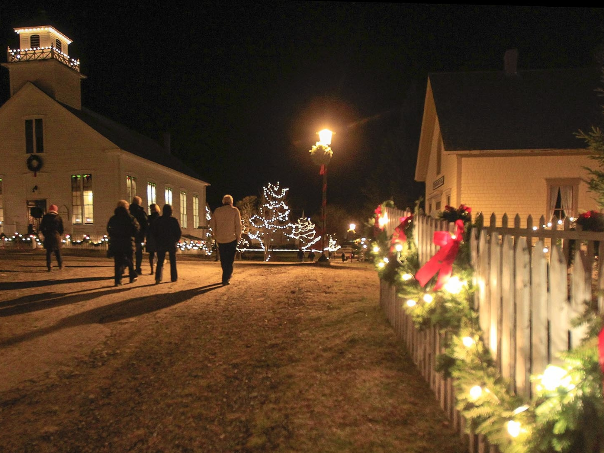 Christmas at Sherbrooke Village, night time, the village is covered in lights.