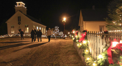 Christmas at Sherbrooke Village, night time, the village is covered in lights.