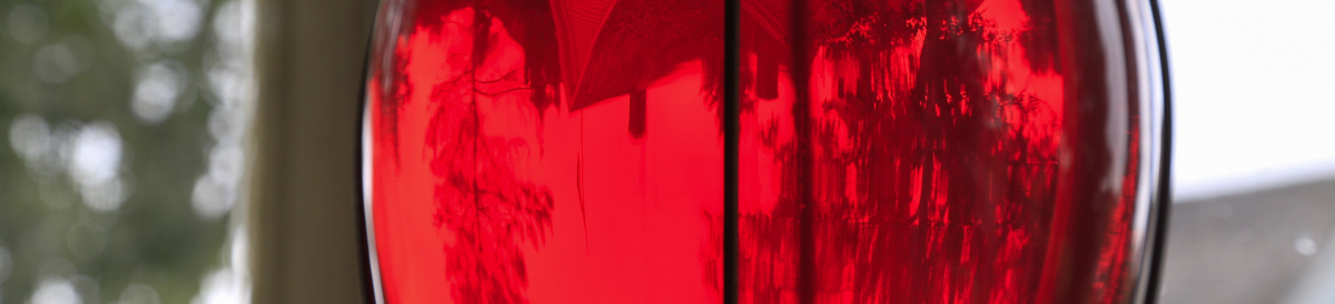 Decorative red glass hanging in a window.